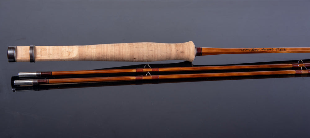 Fishing rod with cork handle on a gray background
