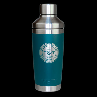 Teal 20oz YETI Ranbler Rumbler with Stainless Steel Cocktail Shaker Lid. Silver Engraved T&T Logo Badge in the center.