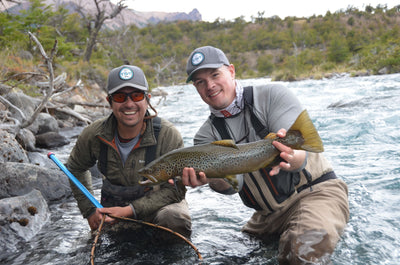 Two fly fisherman holding their catch which was caught with a Thomas & Thomas fly rod